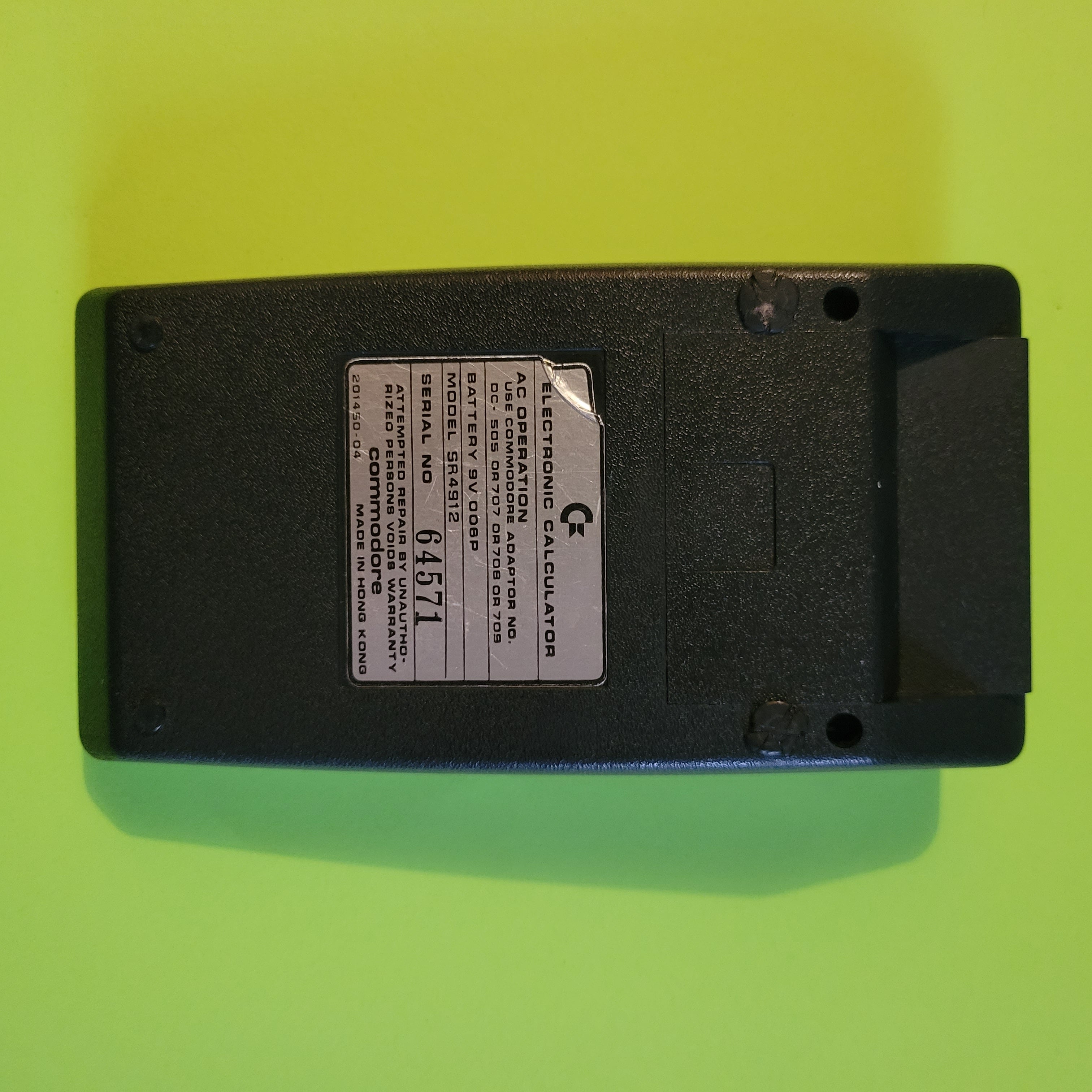 An image of the back of a Commodore SR4912 scientific/engineering calculator